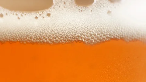 Macro close up of a glass of beer with gorgeous white foam Stock Footage 112497640