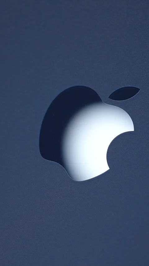 Macro Close-Up of Glossy Apple Logo on Deep Blue iPhone 17 Pro with Bright Light Stock Footage 318057194