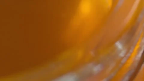 Macro Close Up of Golden Honey Inside Glass Jar Showing Thick Natural Sweet Stock Footage 339763650
