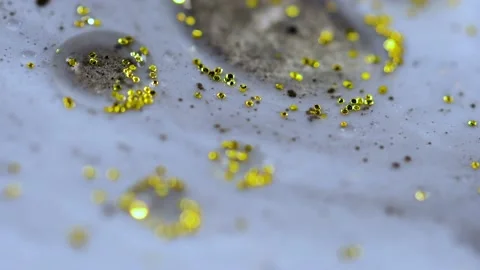 Macro close up of Golden Wet Glitter Particles of acrylic paint and oil. Video stock 150576245