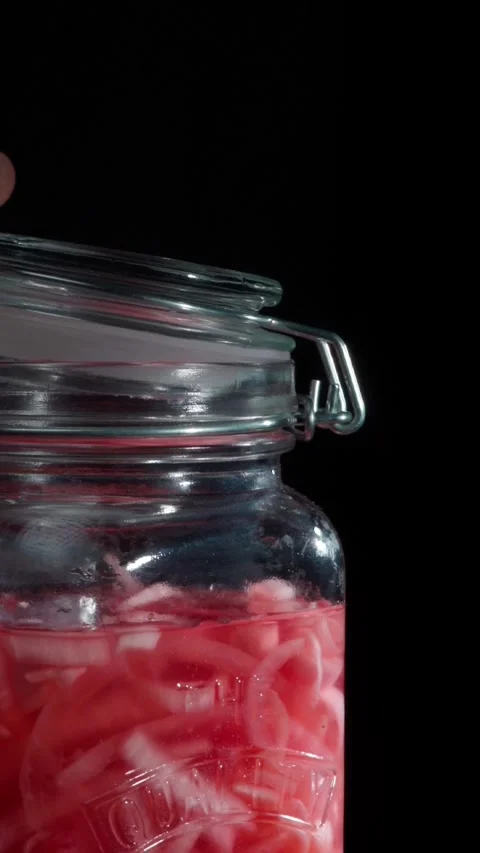 Macro Close Up Hand Closing Glass Jar Mechanism With Pickled Onions Stock Footage 324769498