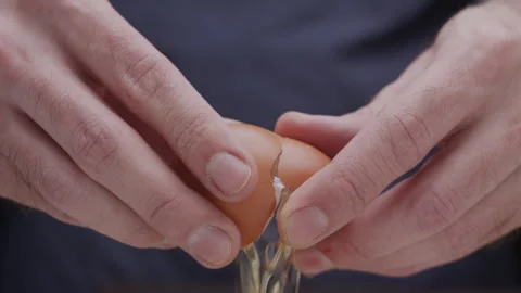 Macro close up of hands breaking an egg Stock Footage 274278622