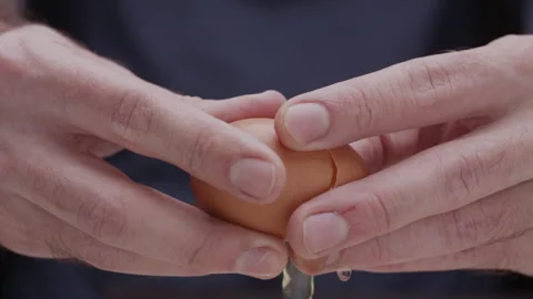 Macro close up of hands breaking an egg Stock Footage 274280672