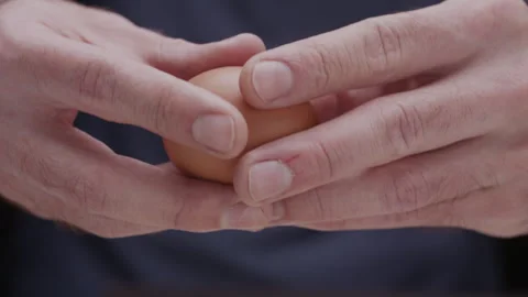 Macro close up of hands breaking an egg Stock Footage 274280846
