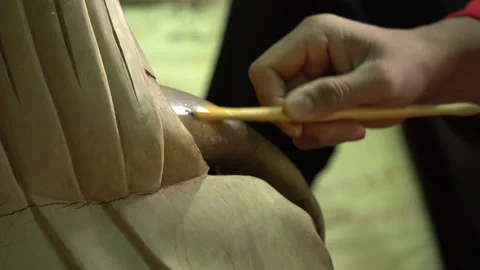 Macro Close Up of Hands Sculpting Clay Buddha Statue with Wooden Tool 库存影片 346828055