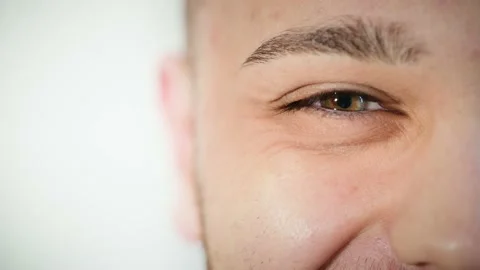 Macro close up of happy man's face smiling with beautiful hazel eye. Stock Footage 167524857