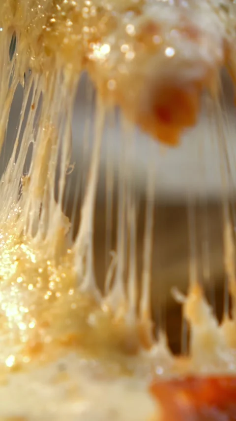 Macro close up of hot pizza slice with stretching melted cheese pulled away.. Stock Footage 337597075