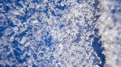 Macro close up of ice crystals on a blue background Stock Photos