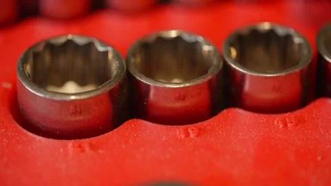 Macro close-up of increasing metric socket set sockets in a red toolbox Stock Footage 328603031