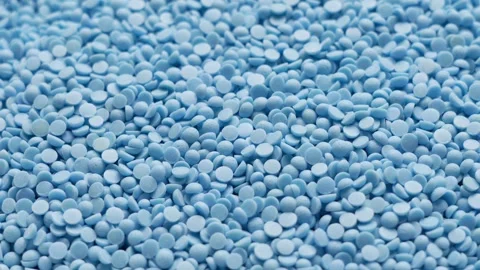 Macro close up of light blue plastic polymer granules forming a textured Stock-Footage 347459306