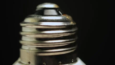 Macro close up of light bulb socket base. Screw base of the bulb rotation w.. Stock Footage 271096755