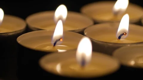 Macro close up of lit small candles rotating around 2 Stock Footage 70243561
