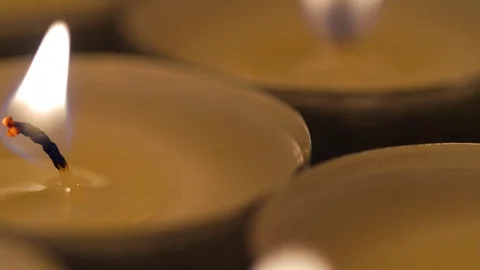 Macro close up of lit small candles rotating around Stock Footage 70243597