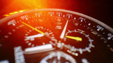 Macro close-up of luxury chronograph watch illuminated by intense orange light Видео 326868967