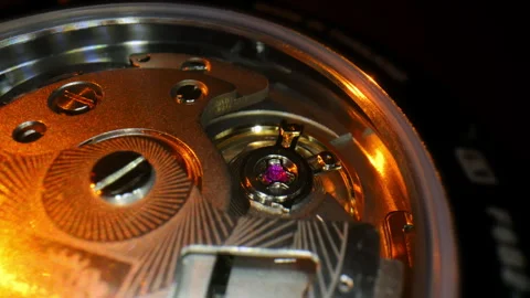 Macro close-up of a luxury mechanical watch movement with a visible ruby jewel Stock Footage 326089295