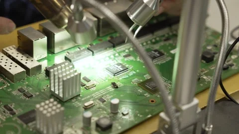 Macro, close up of a man is repairing a chip with a soldering iron. Engineer or Stock Footage 260486464