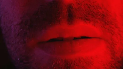 Macro close up on man with seductive facial expression biting his lips Stock Footage 89964315