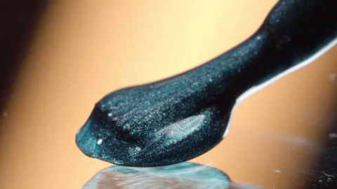 Macro Close Up of Metallic Cosmetic Cream on Black Spatula Showing Smooth Stock Footage 340867720