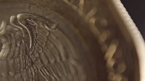 Macro Close Up of Mexican Coin Featuring Eagle and Snake Relief with Metallic Stock Footage 344499907