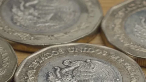 Macro Close Up of Mexican Peso Coins Showing Eagle Emblem and National Stock Footage 345898581