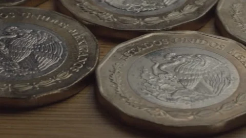 Macro close up of Mexican ten peso coins showing eagle and snake design on Stock Footage 343969199