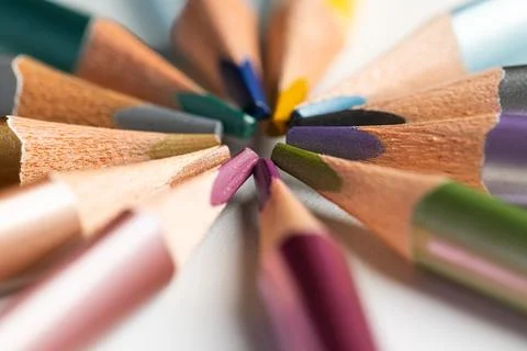 Macro close up of multicolored metallic pencils arranged in circle pattern .. Stock Photos