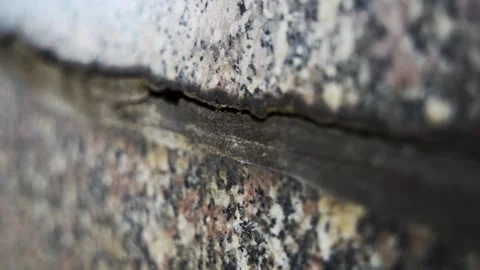 Macro close up of a natural stone texture with a deep crack in the surface, as t Stock Footage 341985356