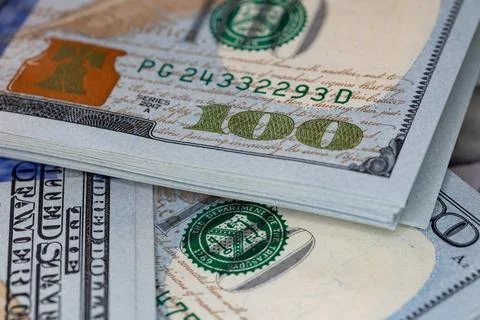 Macro close-up of new one hundred US dollar bills with selective focus on t.. Stock Photos