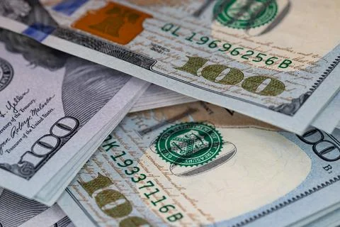 Macro close-up of new one hundred US dollar bills with selective focus on t.. Stock Photos