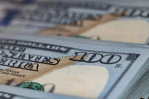 Macro close-up of new one hundred US dollar bills with selective focus on t.. Stock Photos