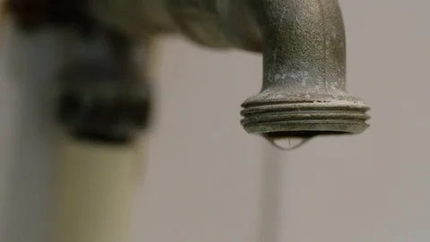 Macro, Close up of old faucet dripping, leaking. Water being wasted. Stock Footage 98001747