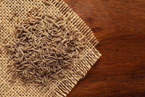 Macro close-up of Organic cumin seed (Cuminum cyminum) or jeera on the wooden Stock Photos