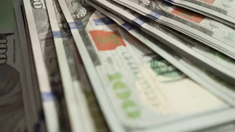 Macro close up. Paper bills American 100 dollars on glass table opposite window Stock Footage 150449433