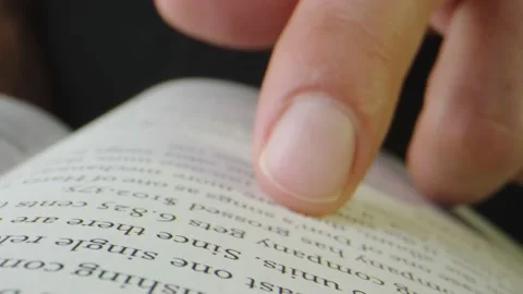 Macro close-up of person reading music publishing book with finger Stock Footage 130596188