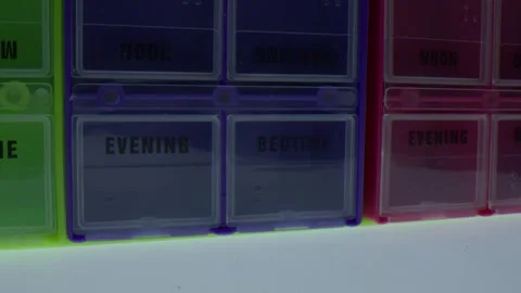 Macro close up of pill boxes labeled evening and bedtime slowly spinning in Stock Footage 326301125