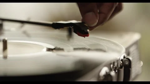 Macro Close-up of Placing Needle on Spinning Vinyl Record Stockbeeldmateriaal 330239765