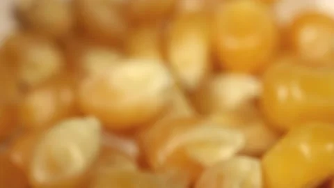 Macro close up of popcorn kernels falling into a white bowl Stock Footage 156461387