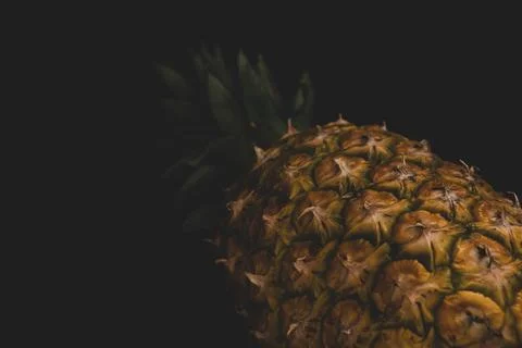 Macro close up portrait of a Pineapple, black background Stock Photos