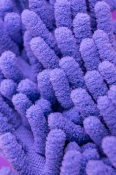 Macro close up of purple chenille microfiber texture for cleaning, trapping d Stock Photos