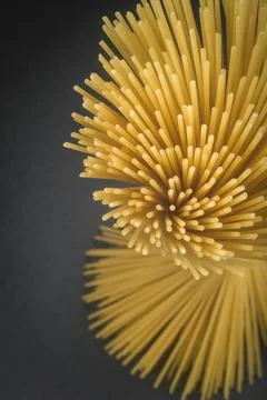 Macro Close-up of Raw Spaghetti Pasta Ends on Dark Background Stock Photos