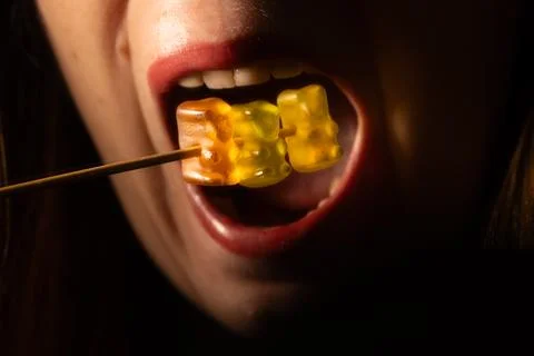 Macro close-up of red lips and open mouth with orange. 스톡 사진