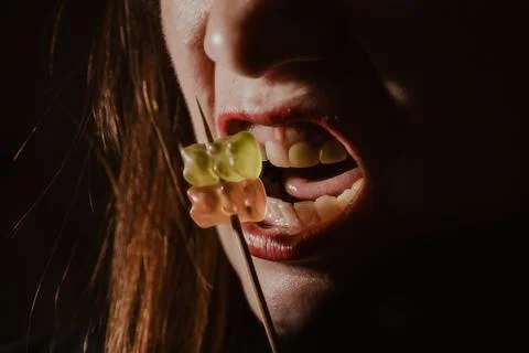 Macro close-up of red lips and open mouth with orange. Fotos de archivo