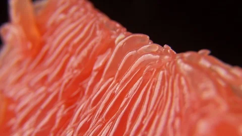 Macro Close up of Red Peeled Grapefruit slice rotating Stock Footage 122256794