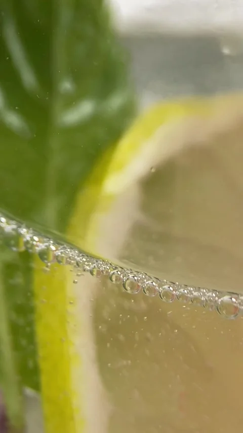 Macro close-up refreshing cold cocktail with lime. soda water covered with Stock Footage 271620792