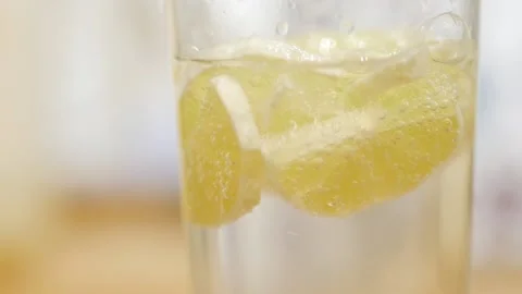 Macro close-up of refreshing soda tonic fizzy water, lime in Glass. Slice of Video stock 143780807