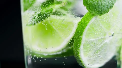 Macro close-up,refreshing soda tonic fizzy water, lime in Glass, ice. Slice of Stock-Footage 148161614
