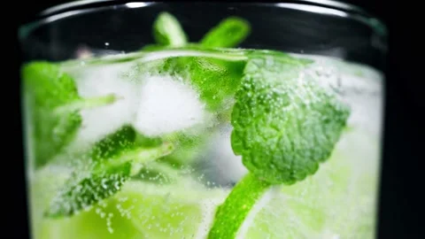 Macro close-up,refreshing soda tonic fizzy water, lime in Glass, ice. Slice of Stock-Footage 148161749
