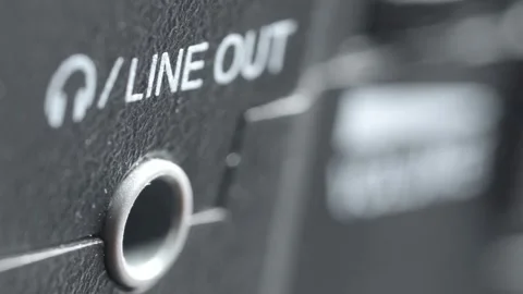 Macro close up of removing audio cable from line out port on electronic device Stock Footage 340193142