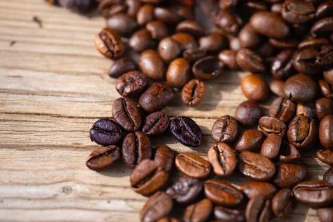 Macro close-up of roasted coffee beans scattered. Photos