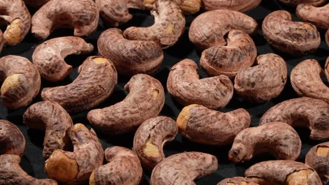 Macro Close-up of Rotating Salt-Roasted Cashews with Skin. Video stock 332838207